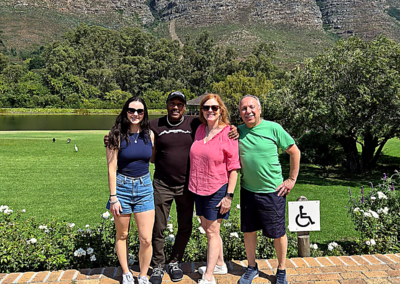 Group of tourists posing with mountains and greenery in Cape Town